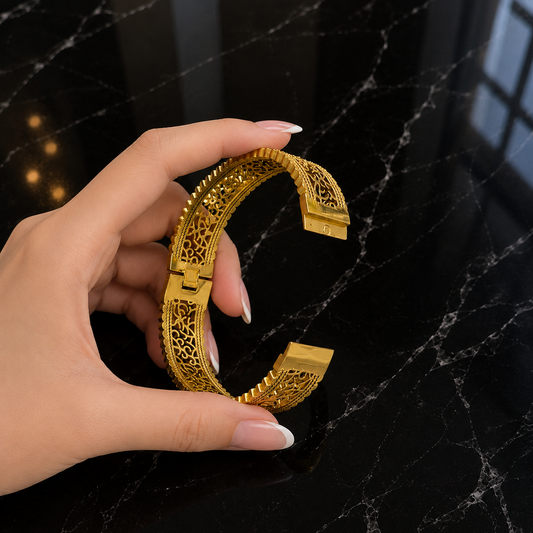Gold-tone Gilded Lattice Cuff shown open, highlighting its intricate openwork design and lock mechanism