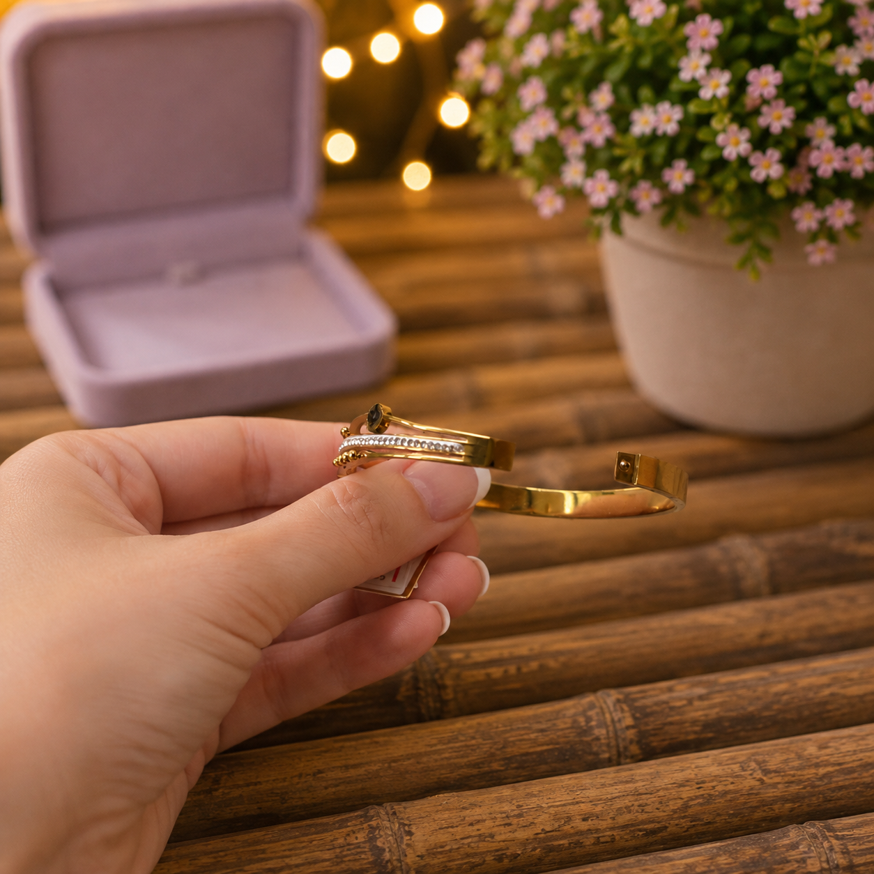 Gold bracelet shown open to highlight the secure lock mechanism and polished finish.