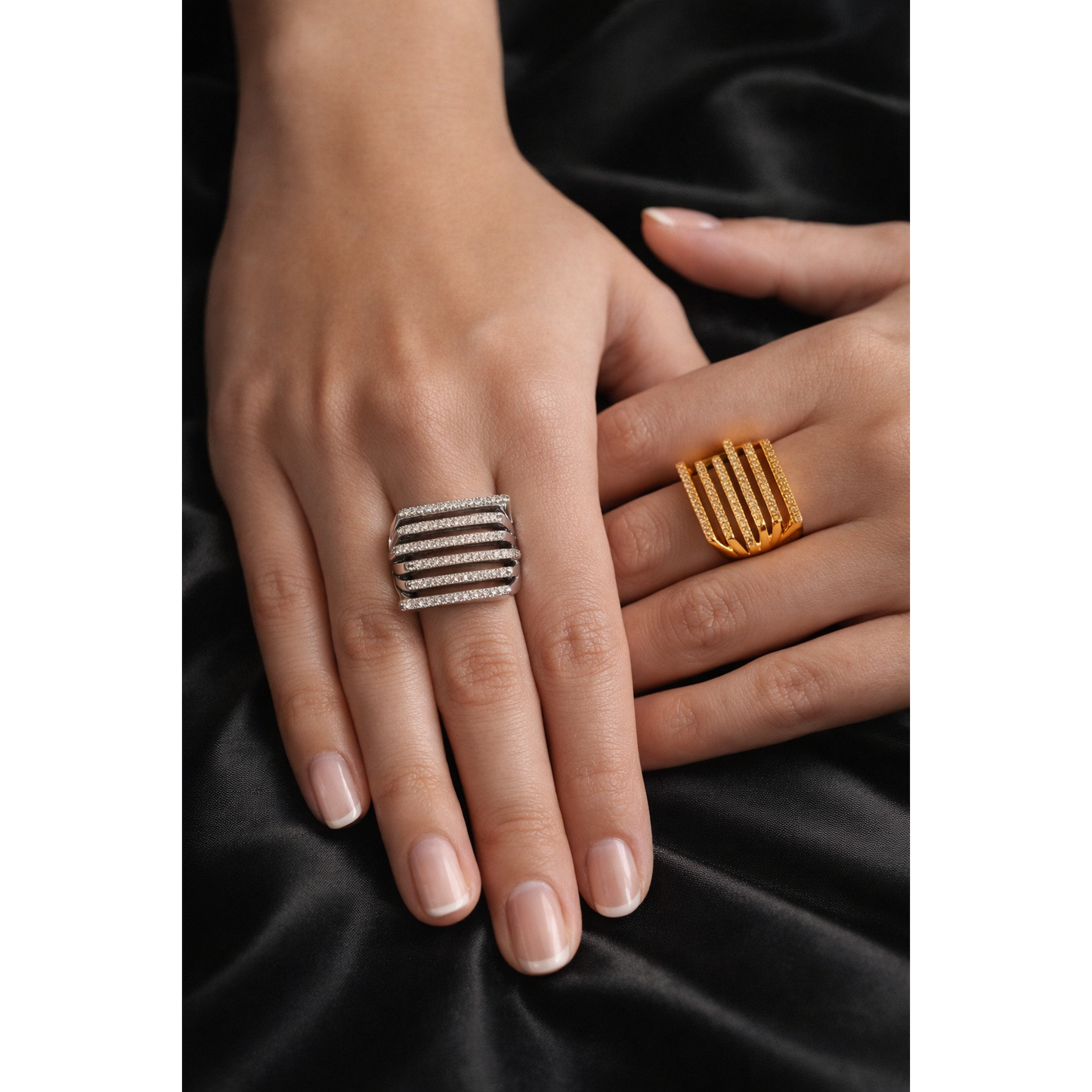 Model wearing gold and silver multi-row pavé bar rings on black satin background