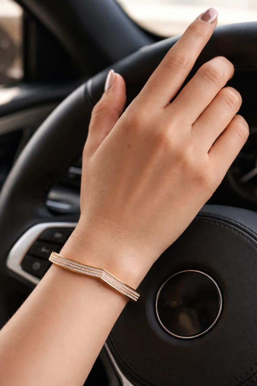 Close-up of gold V-shape bracelet worn on wrist with sleek modern styling