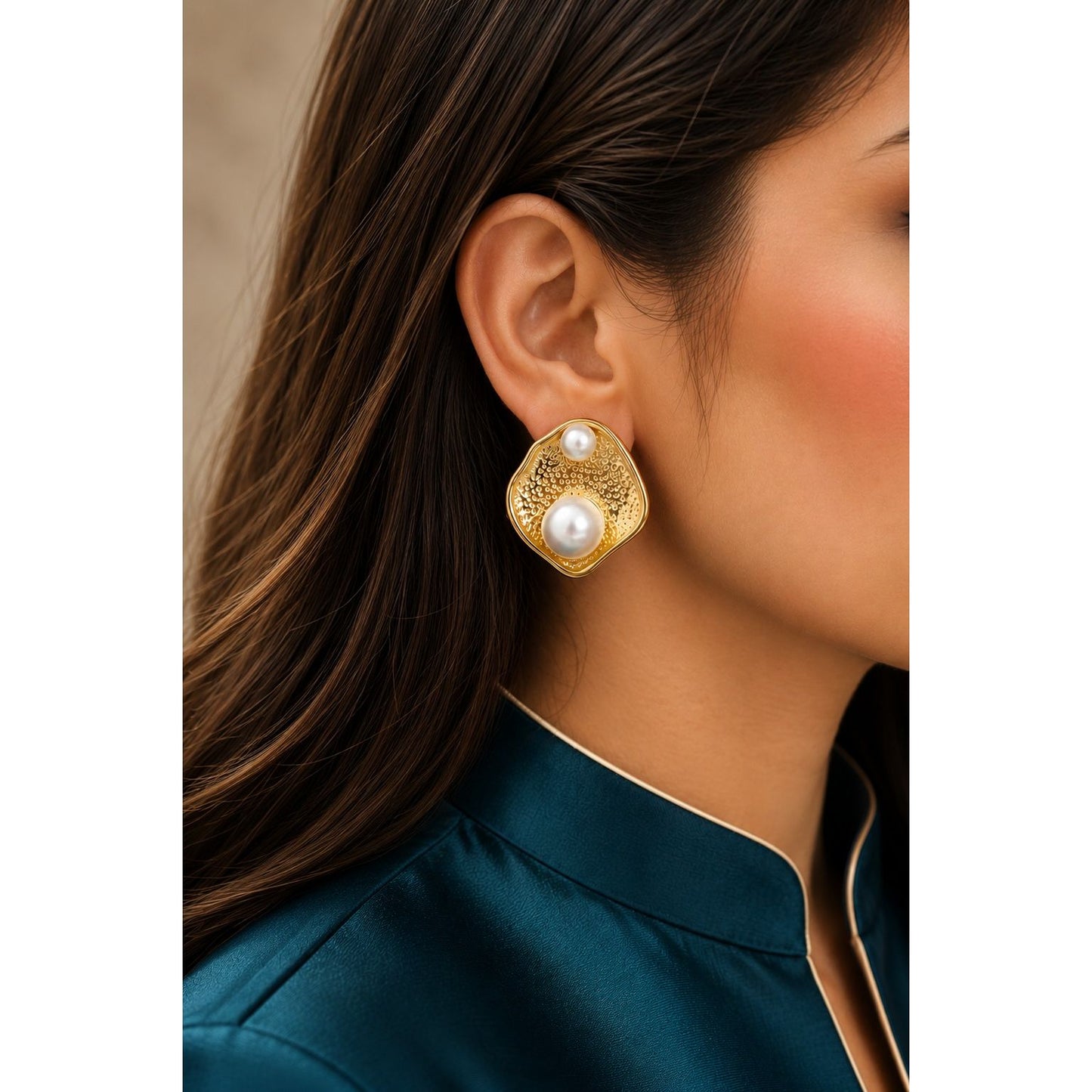 Model wearing organic textured gold stud earrings with dual pearl accents, showcasing contemporary statement earrings for formal and everyday styling.
