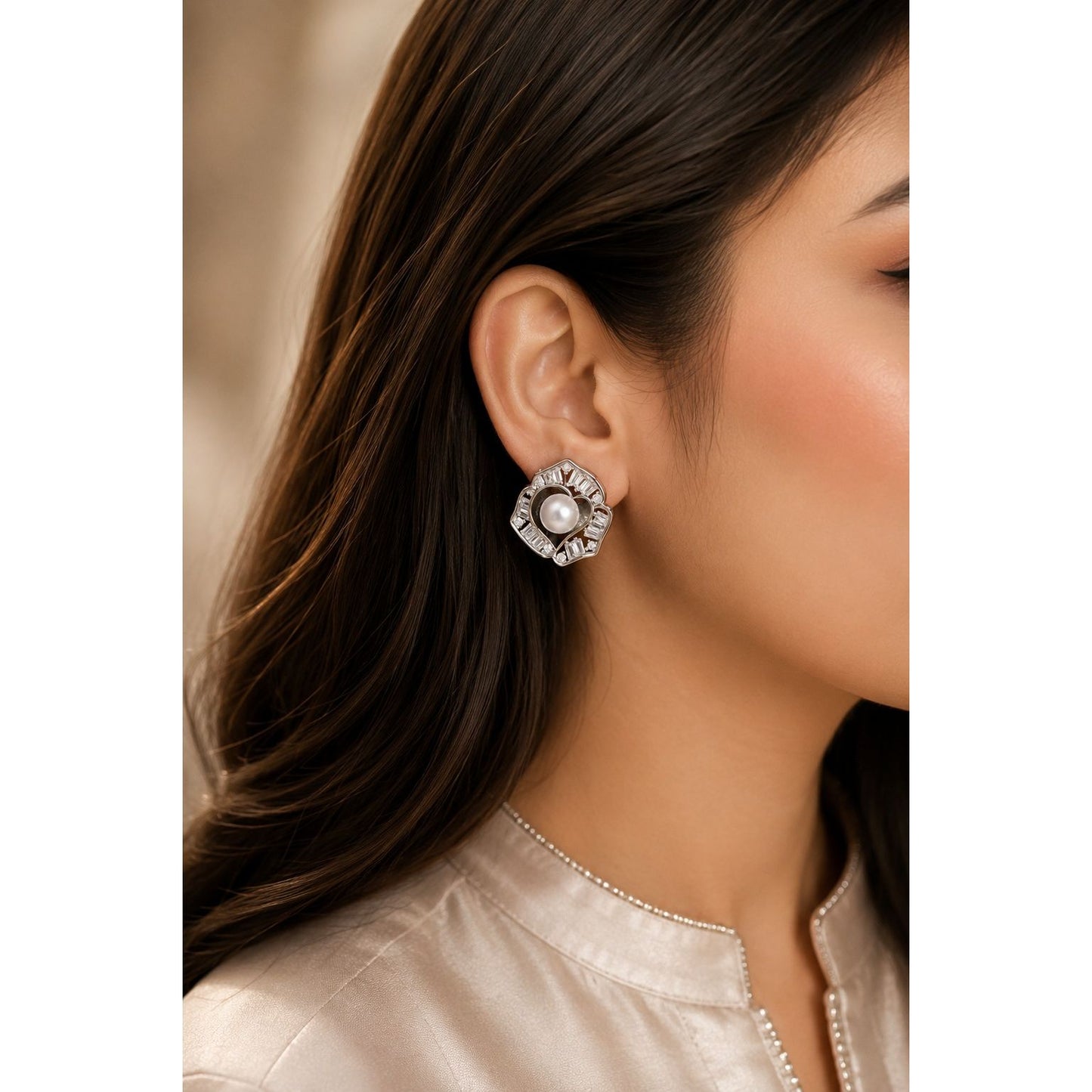Model wearing silver-tone floral stud earrings with a pearl centre and baguette-cut crystals, perfect for bridal, festive, and formal styling