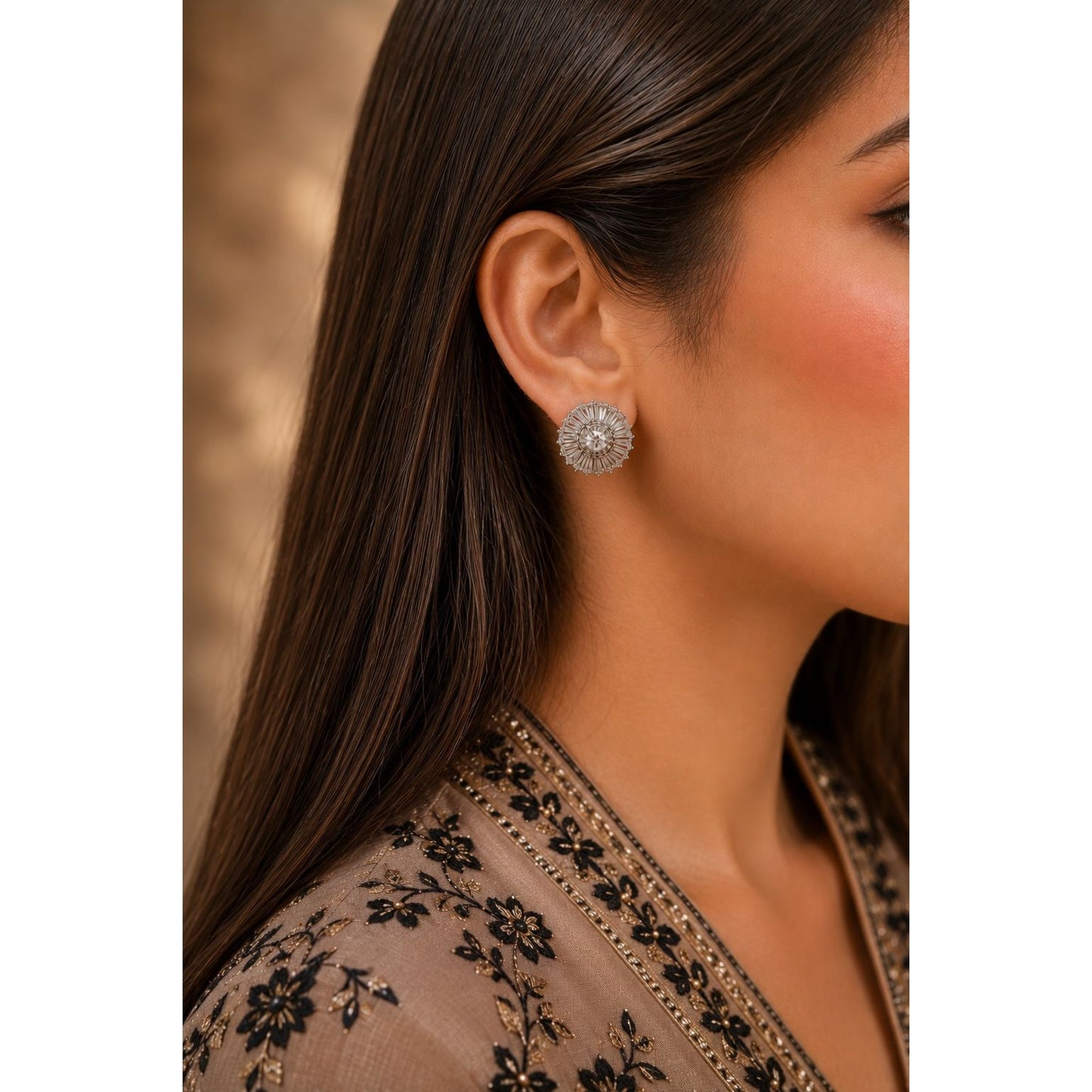 Woman wearing radiant silver halo crystal stud earrings with baguette-cut cubic zirconia in a luxury side-profile portrait.