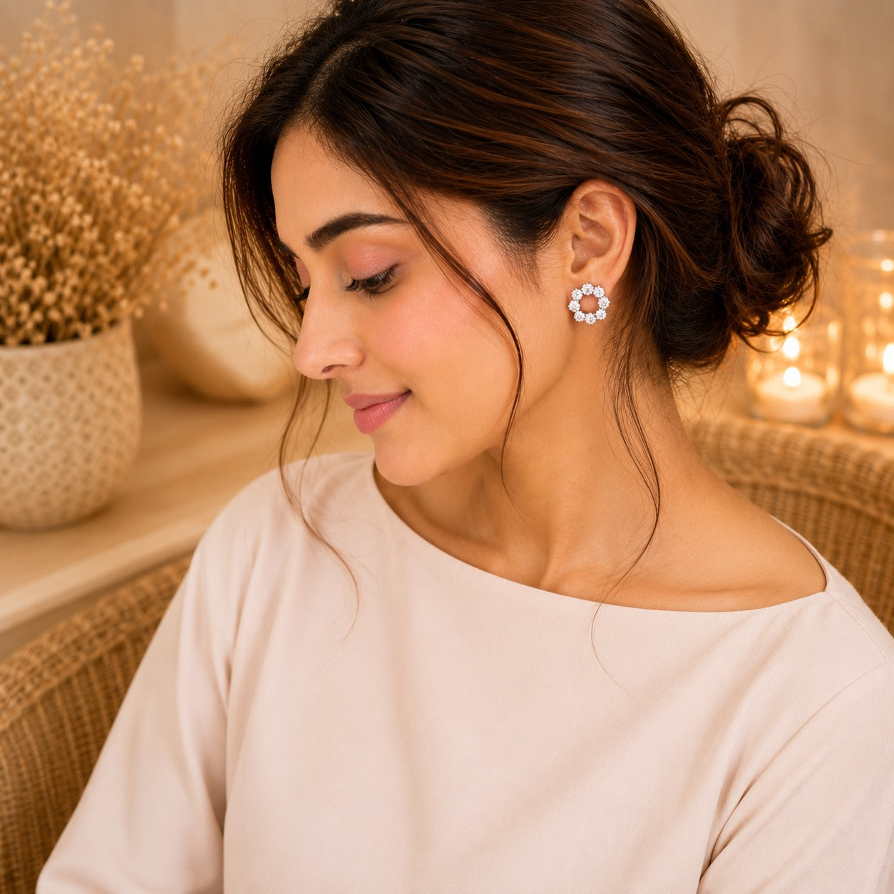 Woman wearing crystal clear floral halo stud earrings with an open-circle design and butterfly stopper back in a soft luxury lifestyle setting