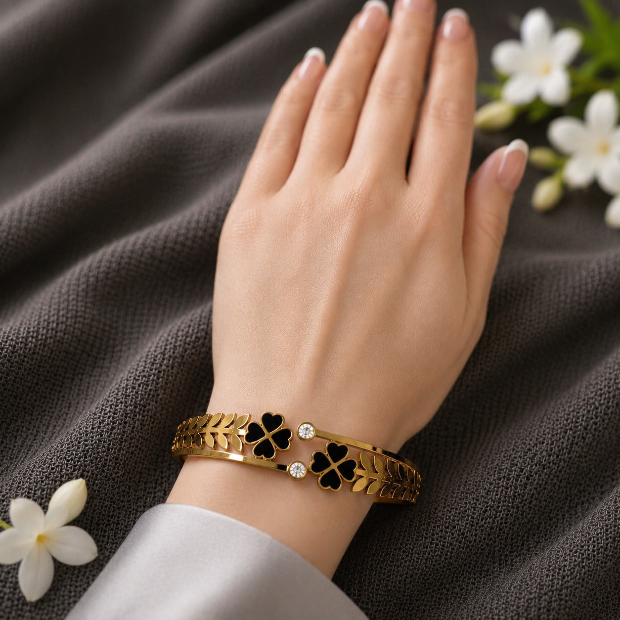 Black clover magnetic bracelet worn on hand, designed for smaller wrists.