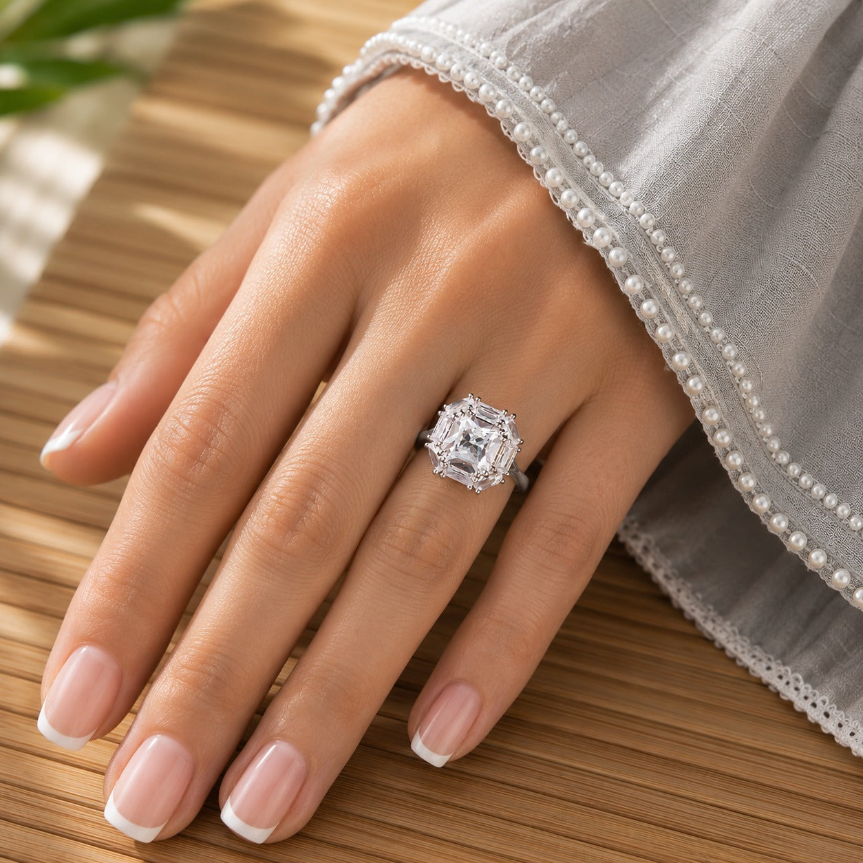S925 Cutglass Square Ring size 6 worn on a hand with French manicure against a natural wood background
