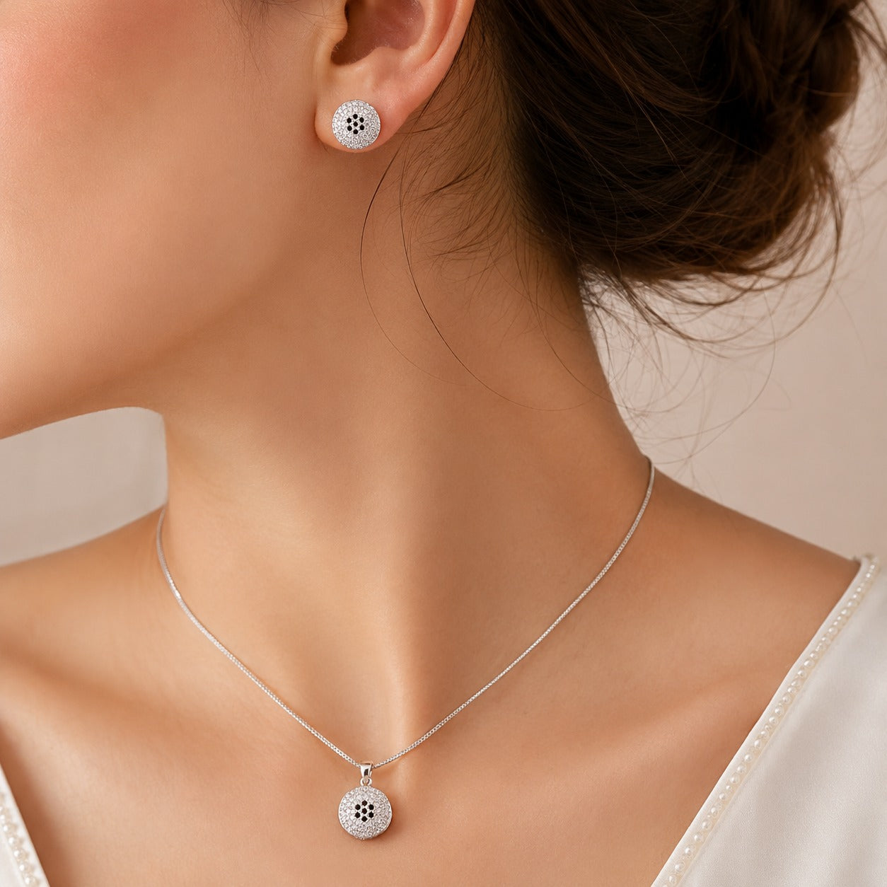 S925 silver Vela Dot pendant necklace and matching round earrings worn together, featuring clear zircon detailing and contrasting dark centre accents