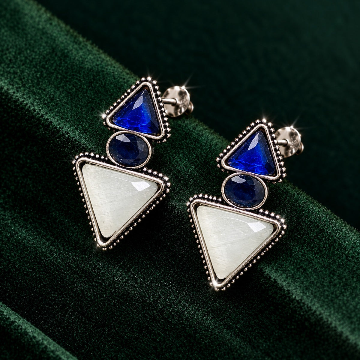 Sapphire blue and ivory Legacy Trine Earrings with opposing triangular stones, oval centre and silver-tone beaded setting.
