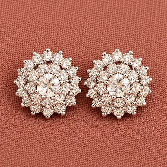 Detailed close-up of clear Kensington Cluster Studs highlighting the faceted mint-green centre stones, intricate circular arrangement and surrounding clear zircon detailing.