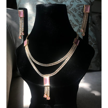 Necklace and earrings set on a black mannequin bust with a decorative background
