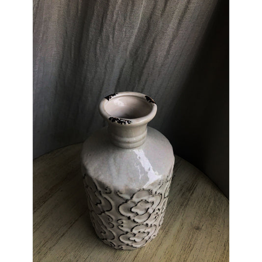 An ornate decorative vase with a classic urn shape, featuring intricate black metallic patterns on a white background