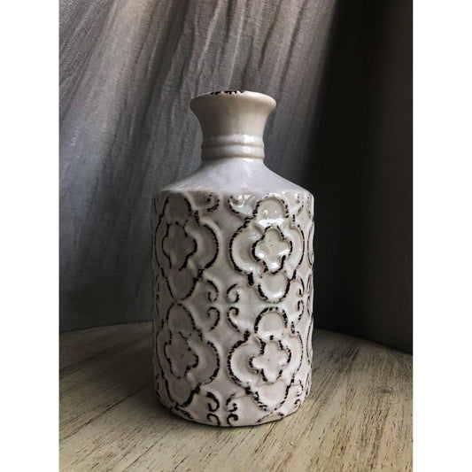 An ornate decorative vase with a classic urn shape, featuring intricate black metallic patterns on a white background