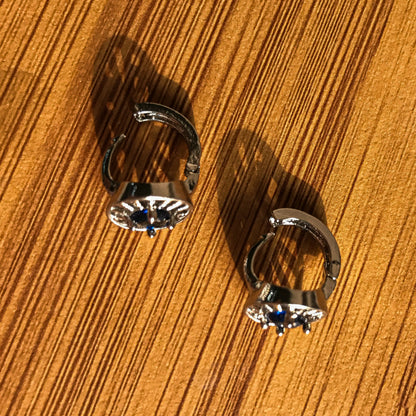 Two silver-colored stud earrings shaped like arc reactors, each with a blue crystal in the center.