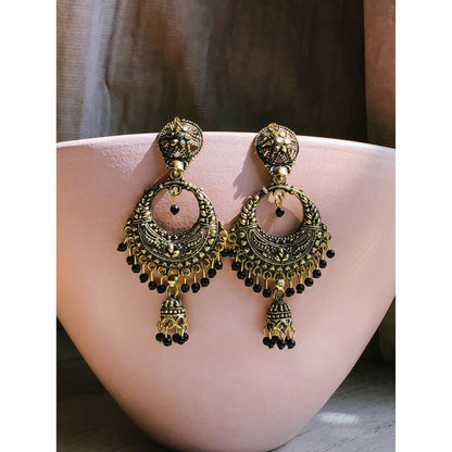 A pair of ornate silver-tone chandbali jhumka earrings featuring a crescent moon design at the top with intricate patterns and a dangling bell-shaped jhumka at the bottom.