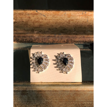 A pair of long, silver-tone drop earrings featuring multiple strands of sparkling clear crystals forming a fringe, with a crystal-studded top.