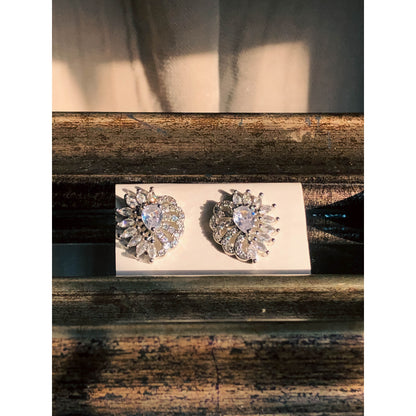 A pair of long, silver-tone drop earrings featuring multiple strands of sparkling clear crystals forming a fringe, with a crystal-studded top.