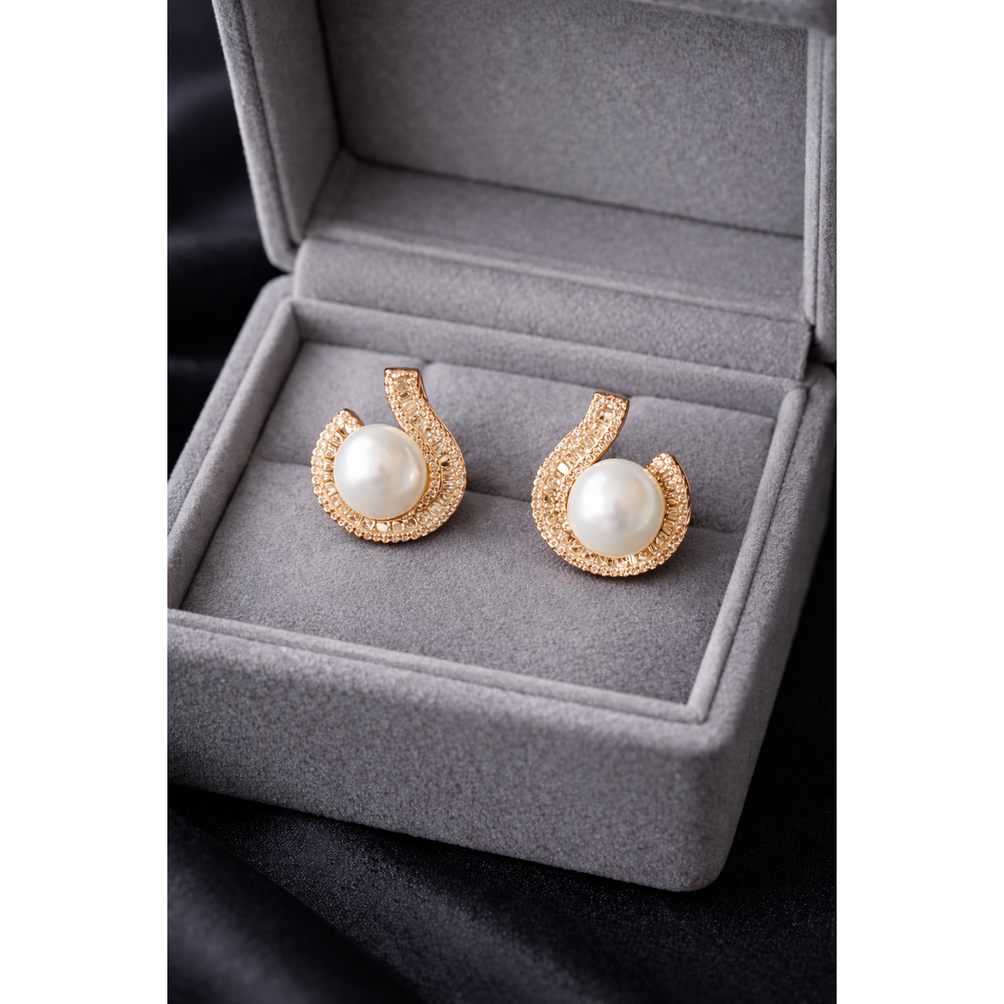 TIAS gold pearl stud earrings with crystal detailing displayed in a luxury grey velvet jewellery box