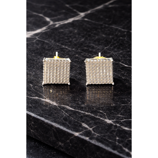 Modern square diamond-style stud earrings on a black marble surface