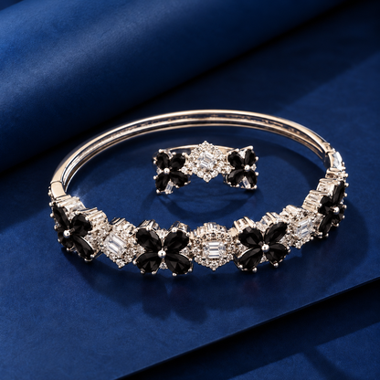 Detailed close-up of the matching floral bracelet and ring highlighting pear-cut gemstone petals, baguette-cut clear stones and intricate zircon borders.