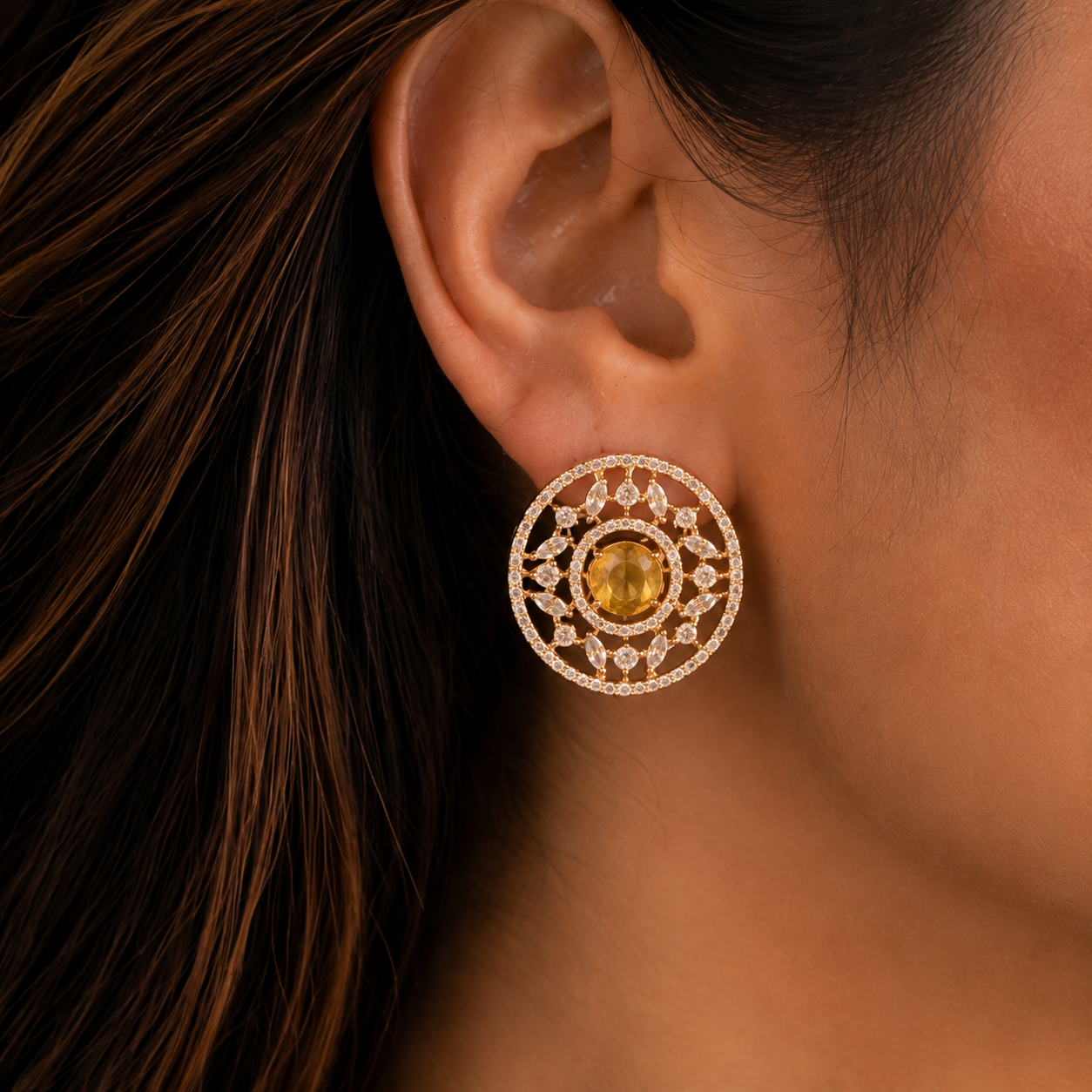  Close up  of a  model wearing  Solstice Studs with golden yellow oval centre stone, marquise zircon accents 