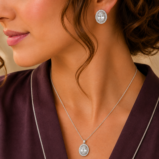 Model wearing matching silver-tone oval clear zircon earrings and pendant necklace with sparkling double-stone borders.