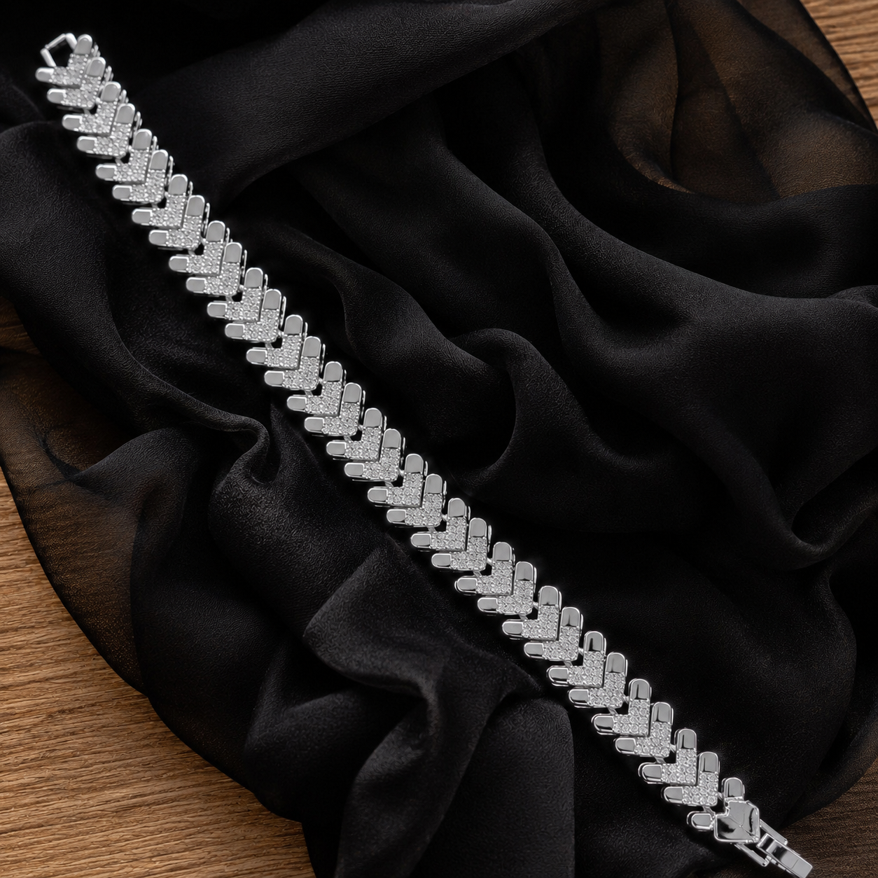 Silver-tone Riven Link bracelet displayed on black fabric, highlighting its repeating angular pattern, clear zircon detailing and polished finish.