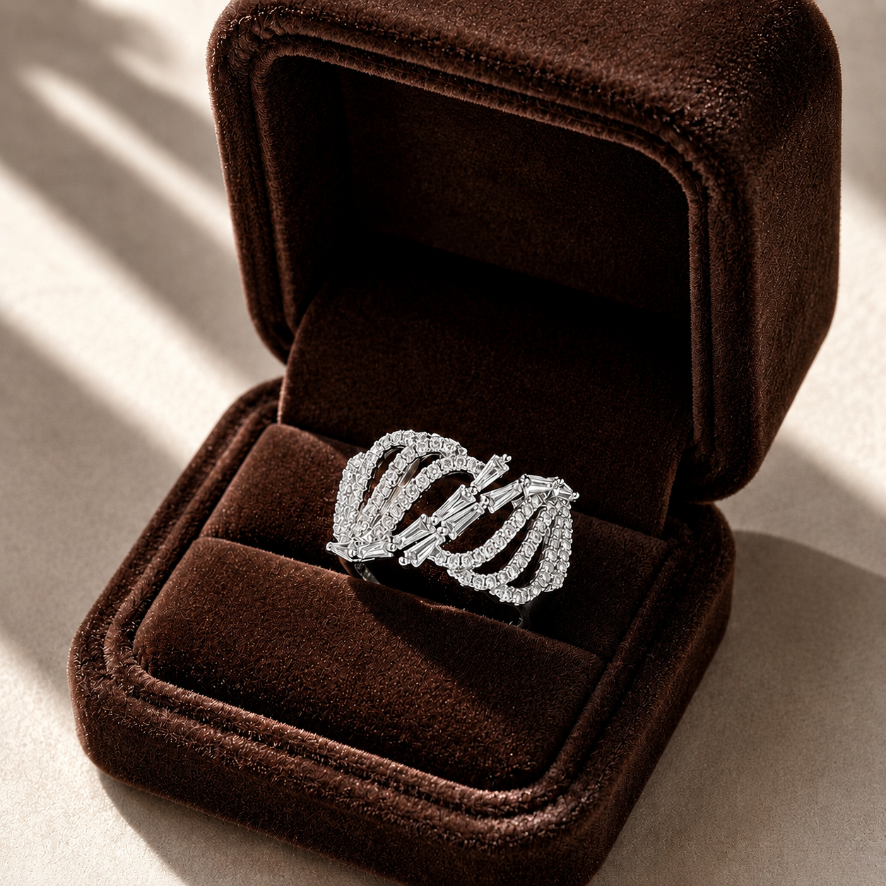 Arcveil silver zircon ring displayed inside a rich brown velvet jewellery box.