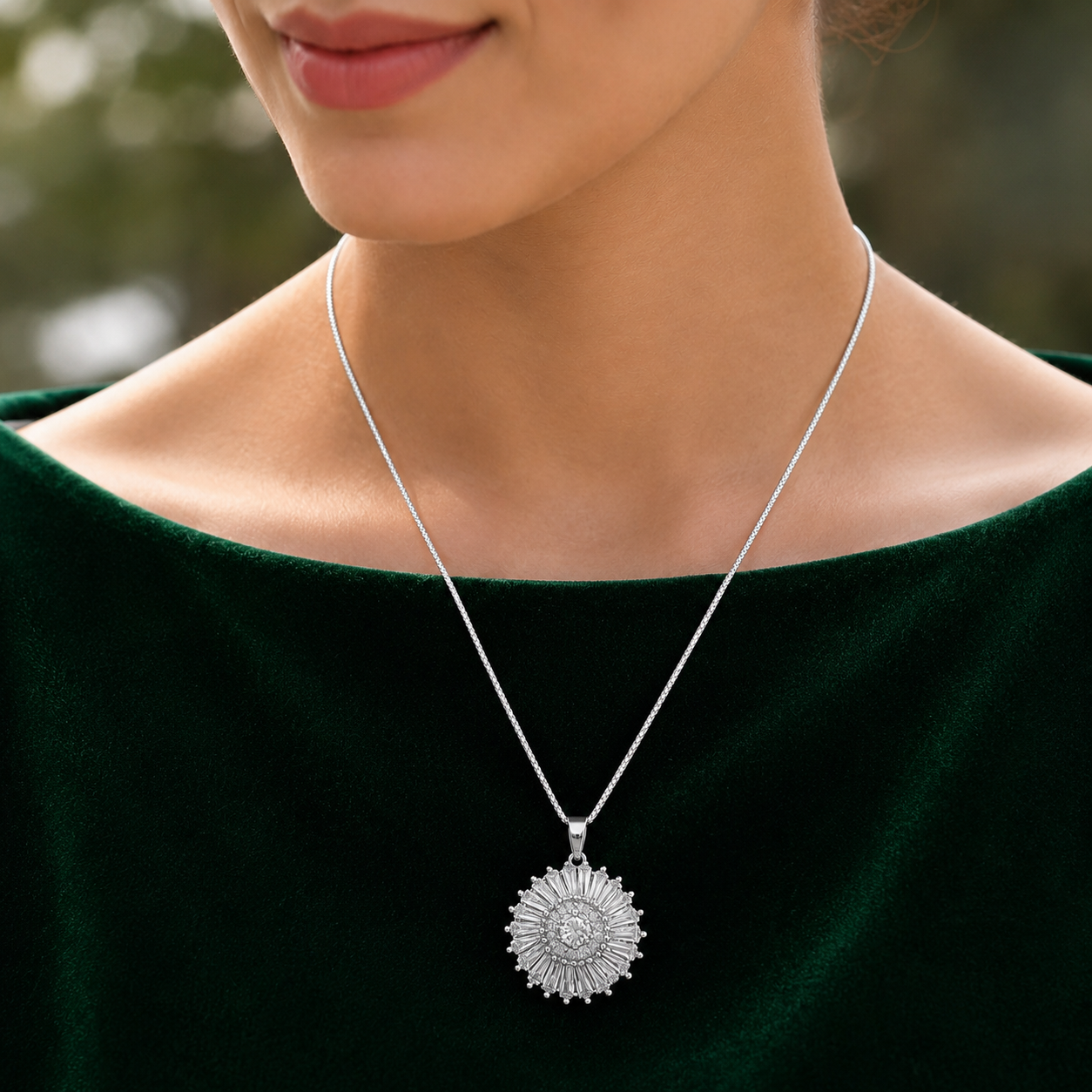 Silver sunburst zircon pendant worn with a deep green velvet outfit, showing its circular radiant design and silver-tone chain.