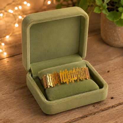 Gold geometric lattice bracelet displayed inside a premium pistachio green velvet bracelet case with secure clasp lock