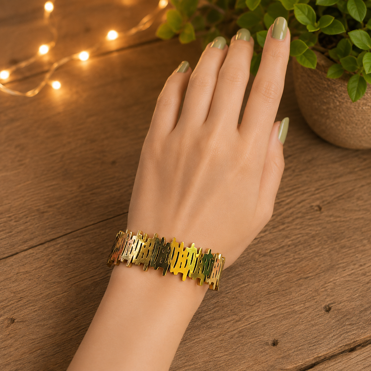 Gold lattice bracelet with clasp lock worn on a hand, showcasing its modern structured design and polished finish.