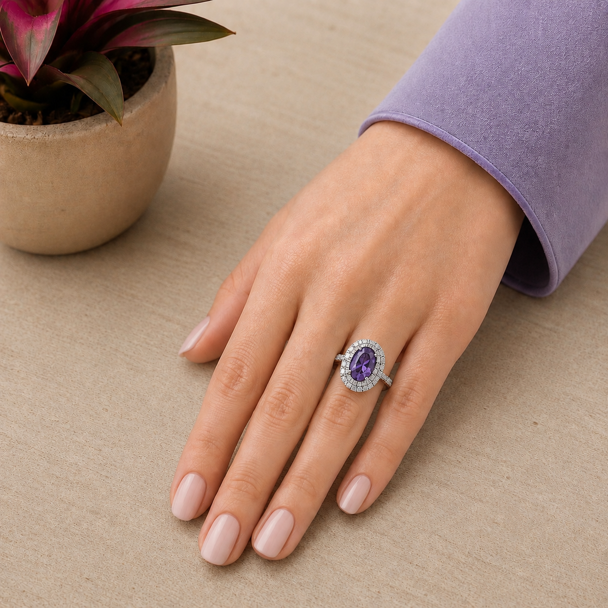 Woman wearing the lavender oval halo statement ring with a coordinated soft lavender manicure