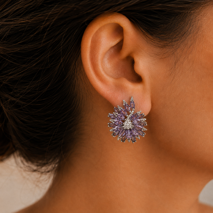 Stellar Crest amethyst purple crystal statement stud earring worn on ear with layered crest design