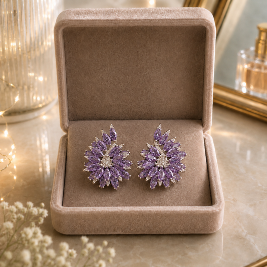 Pair of Stellar Crest amethyst purple crystal stud earrings displayed in soft velvet jewellery box