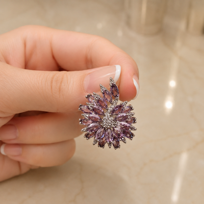 Stellar Crest amethyst purple marquise crystal statement stud earring held in a French manicured hand