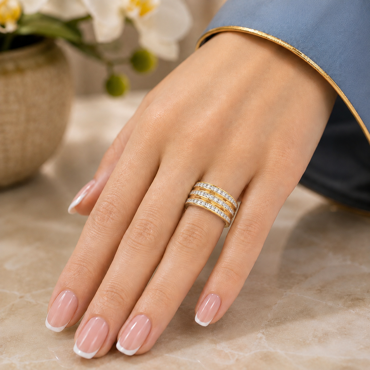 Lumen Trio stainless steel light gold band ring with three crystal rows worn on a French manicured hand