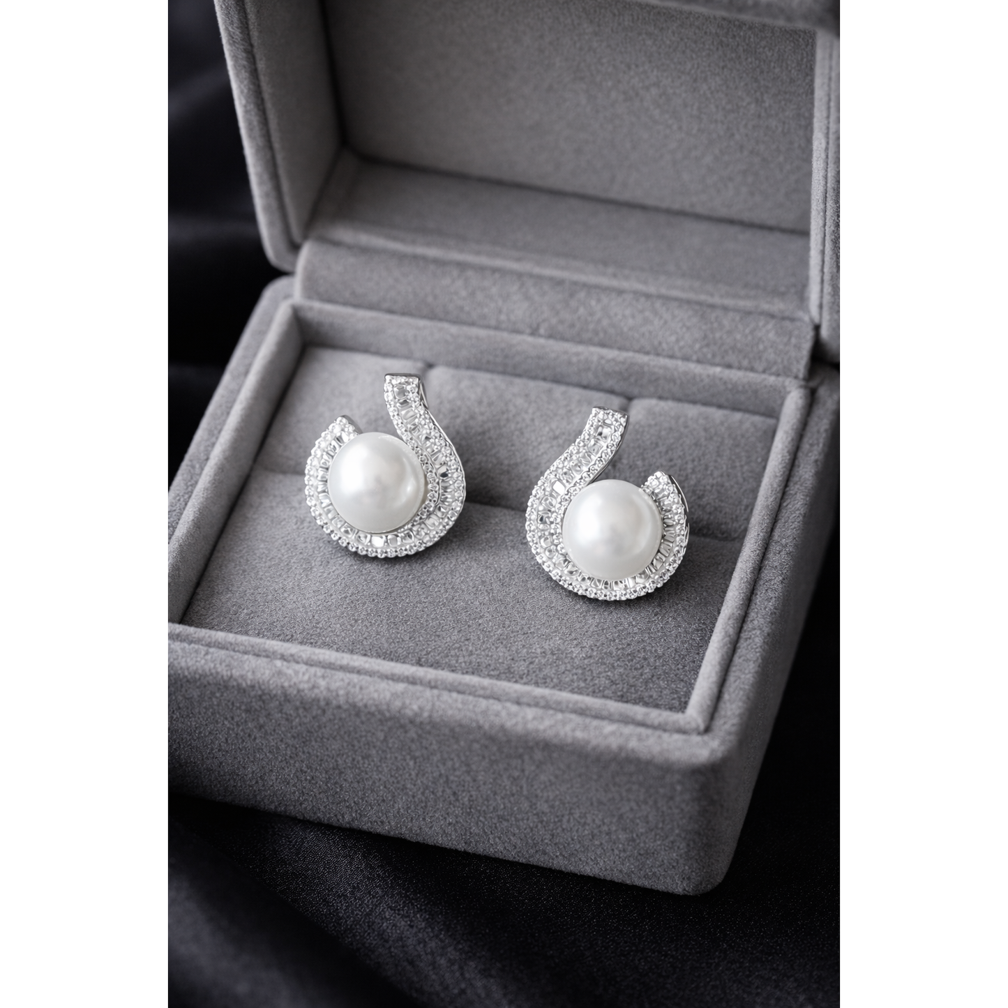 TIAS silver pearl stud earrings with crystal detailing displayed in a luxury grey velvet jewellery box