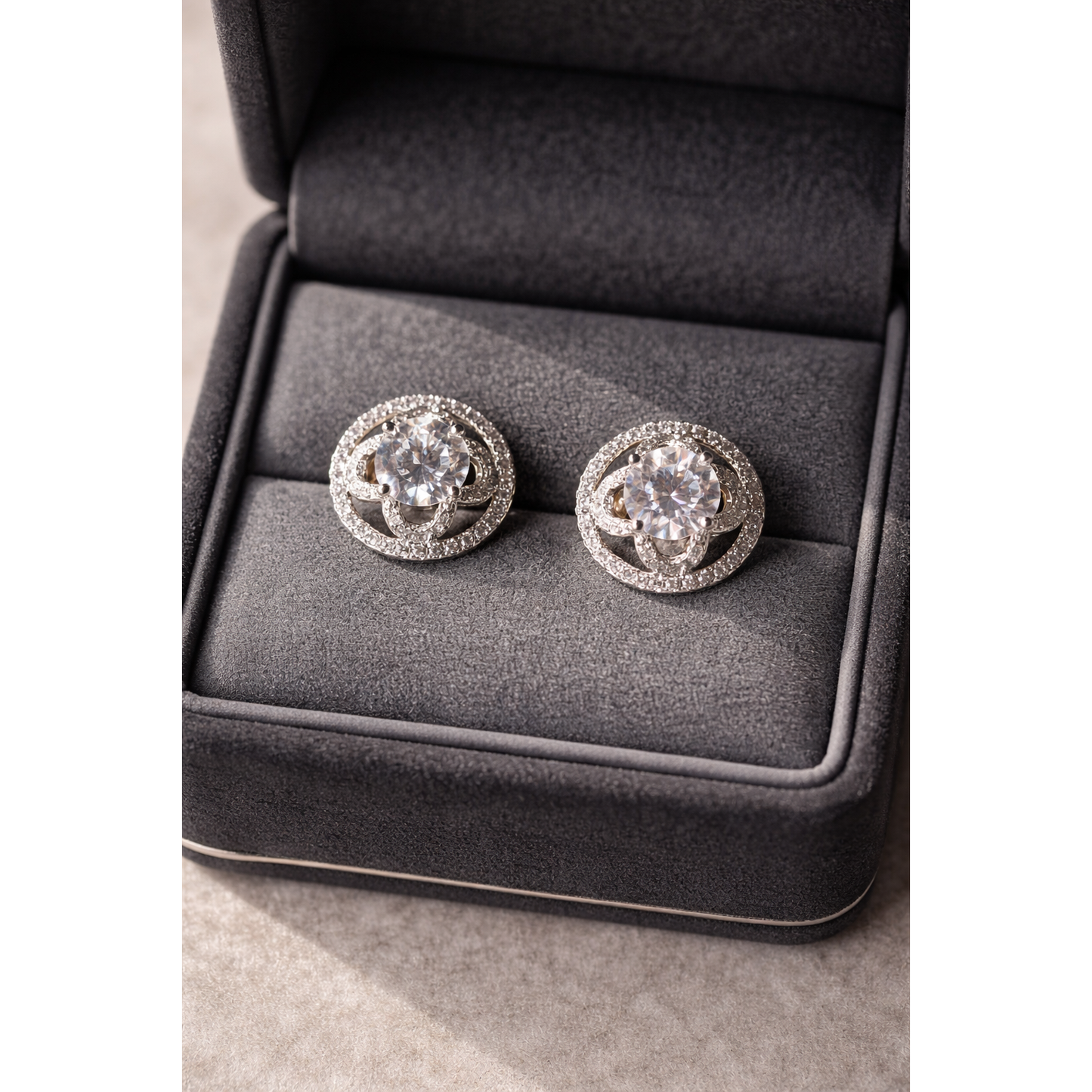 TIAS crystal halo stud earrings presented in a dark grey jewellery box, showcasing elegant sparkle and fine detailing.”