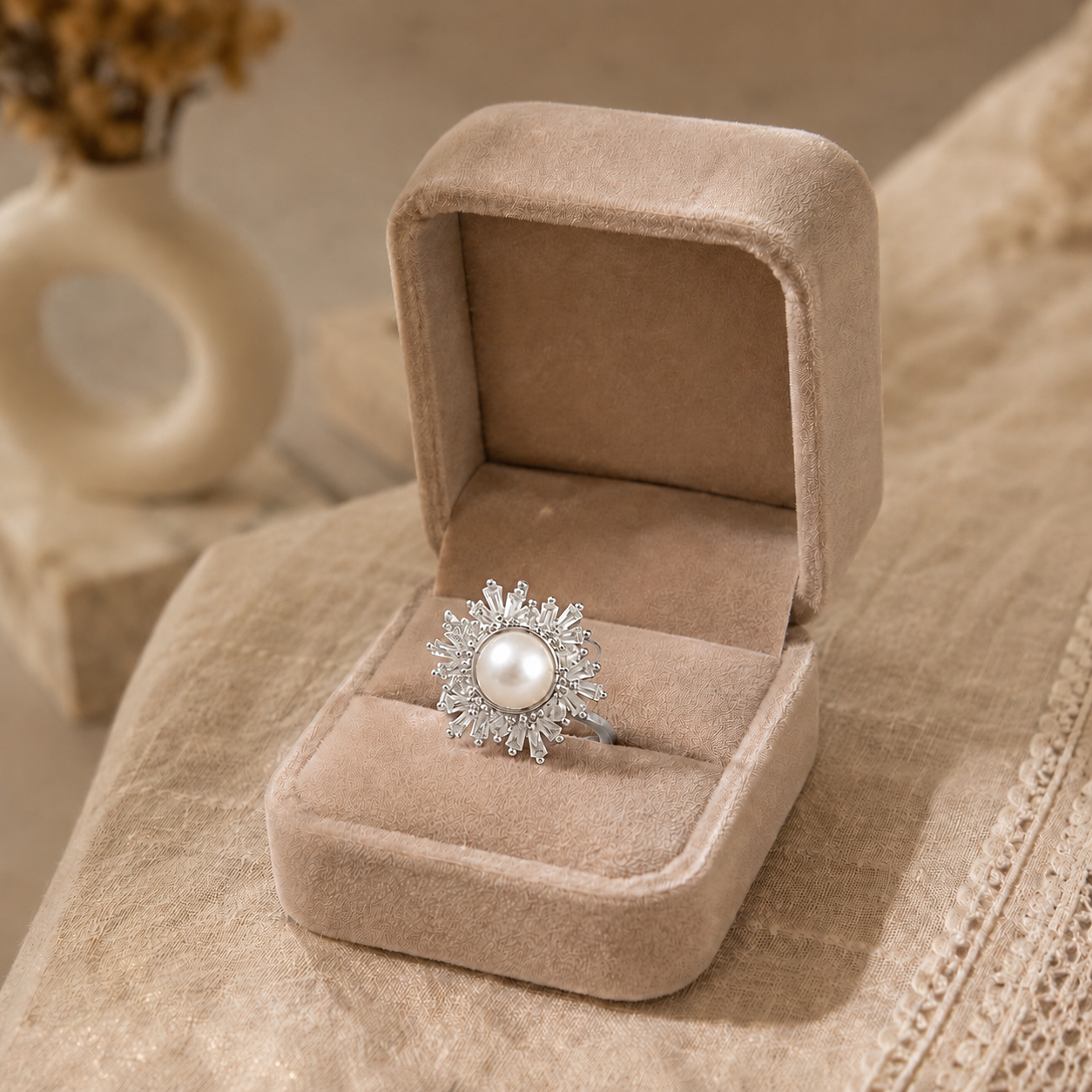 Silver statement ring featuring a natural ivory pearl centre with a radiant sunburst halo of sparkling marquise-cut stones.