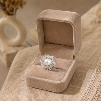 Silver statement ring featuring a natural ivory pearl centre with a radiant sunburst halo of sparkling marquise-cut stones.