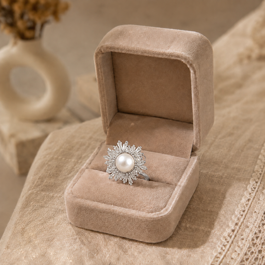 Silver statement ring featuring a natural ivory pearl centre with a radiant sunburst halo of sparkling marquise-cut stones.