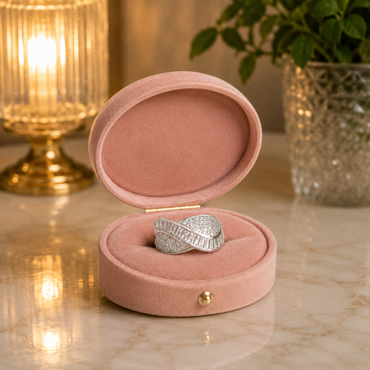 Silver wave statement ring with baguette-cut crystals displayed inside a luxury tea pink velvet jewellery box on reflective marble.
