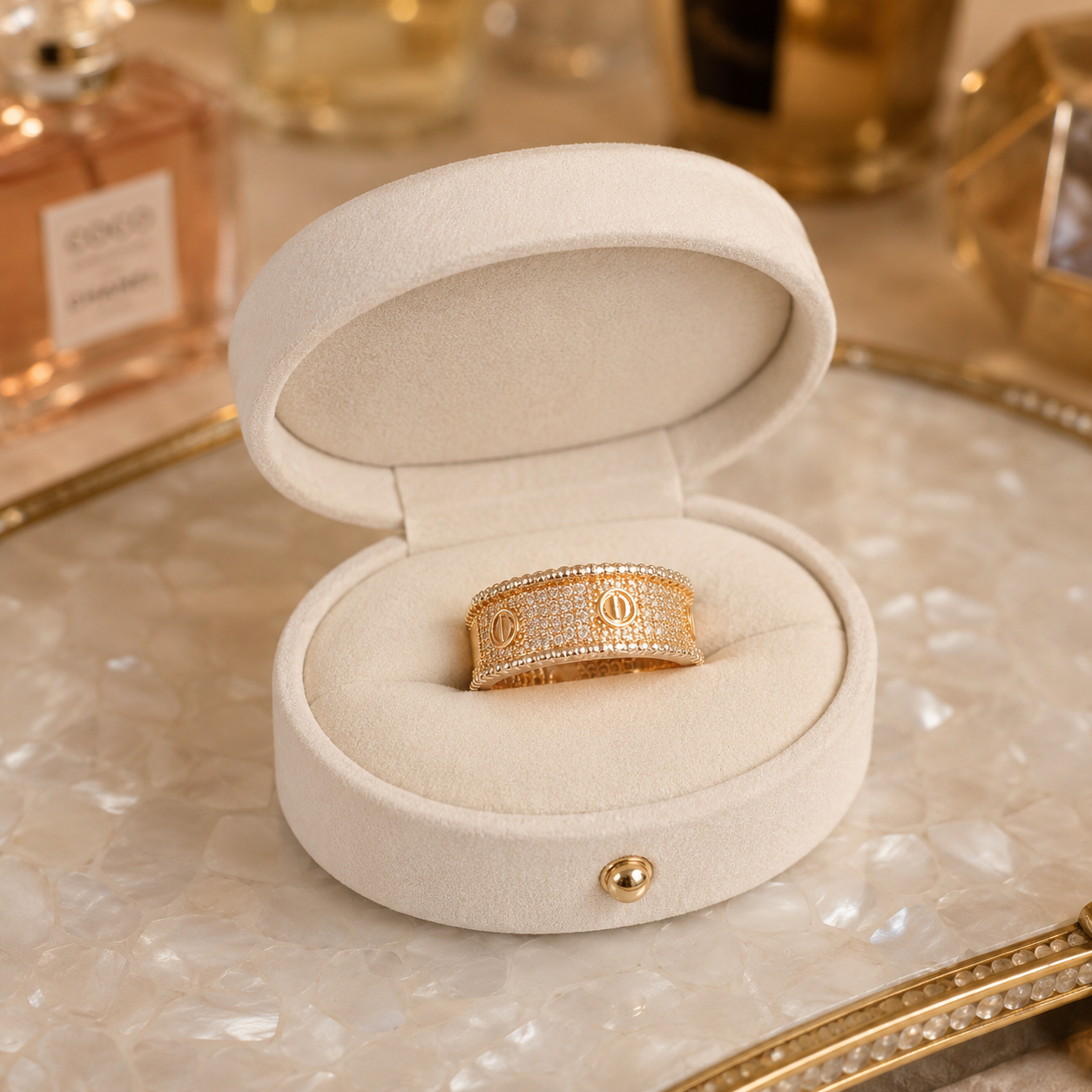 Luxury rose gold pavé crystal signature band ring displayed inside an ivory white oval velvet jewellery box on a pearlized tray