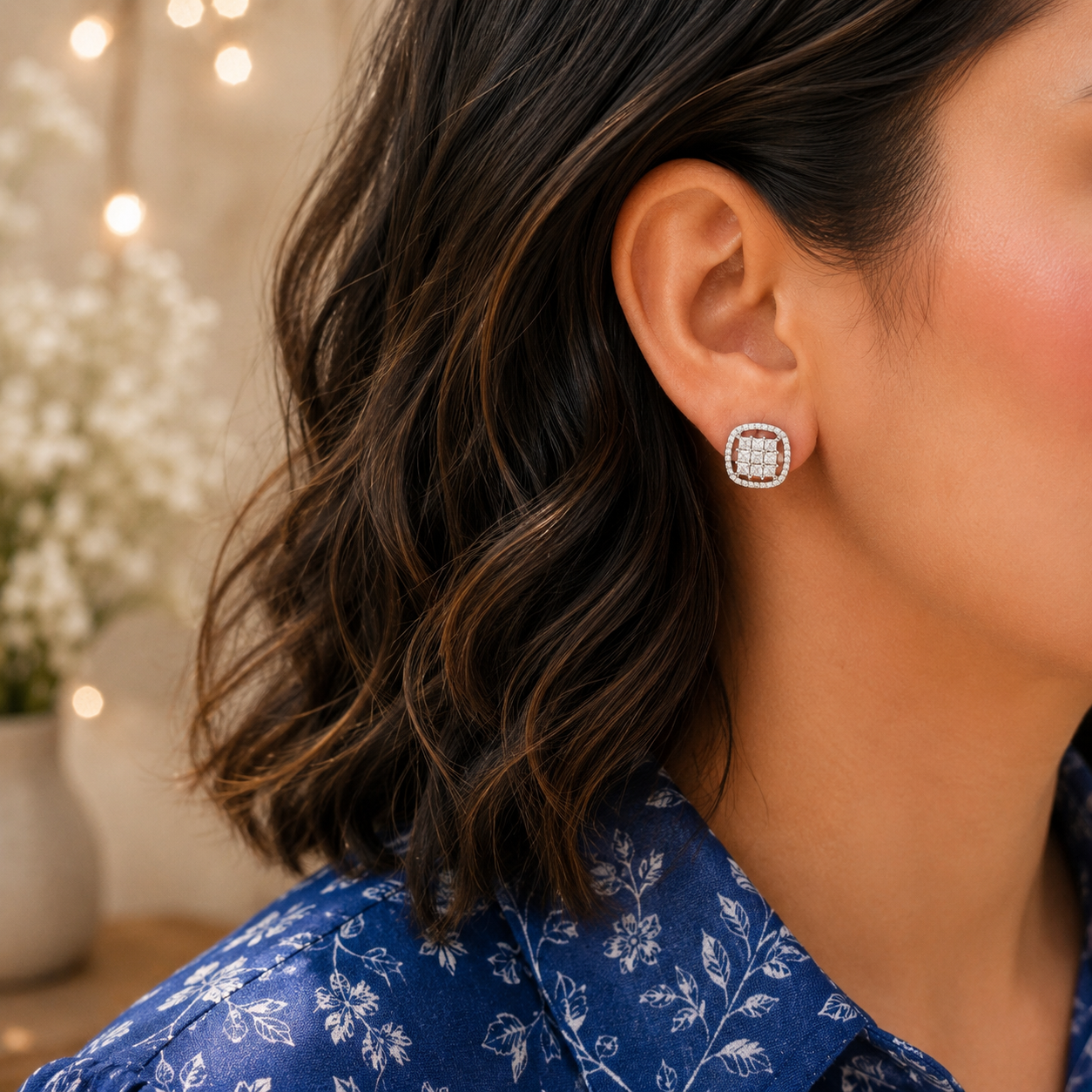Square halo crystal stud earrings worn on a model, featuring a brilliant clustered centre with a sparkling pavé border.