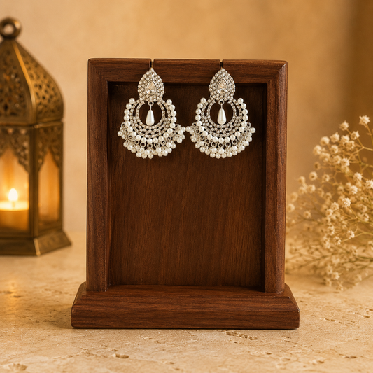 Silver zircon pearl halo drop earrings on premium wooden jewelry stand