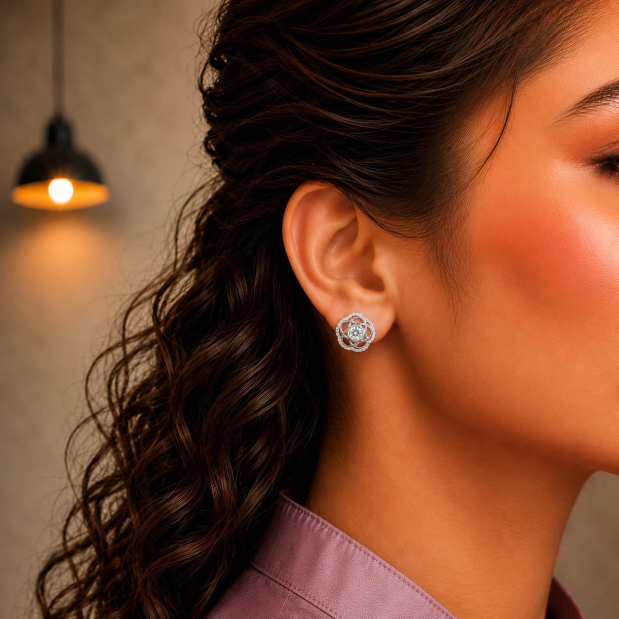 Close-up side profile of a model wearing silver floral stud earrings featuring clear crystal center stones.