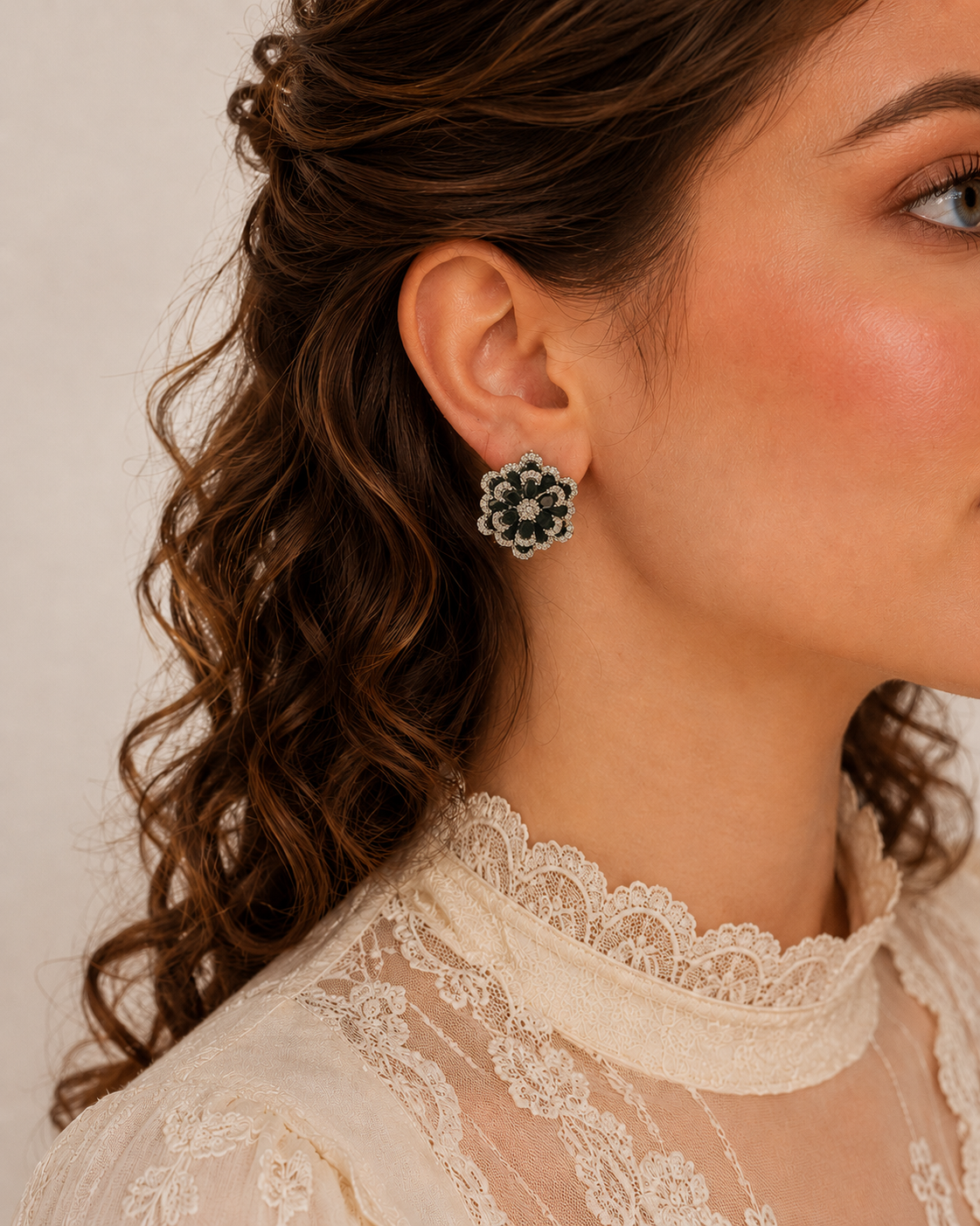 Black floral crystal stud earrings worn by model, statement flower-shaped earrings with crystal detailing and vintage-inspired design.