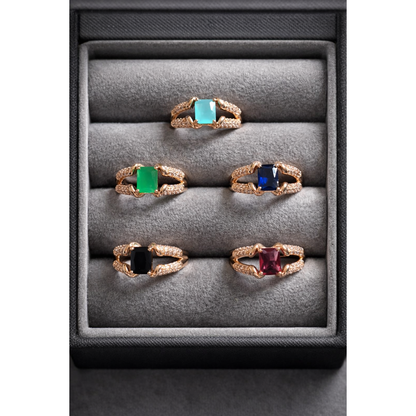 Adjustable square cut artificial stone ring in gold and silver variants displayed in a grey velvet jewelry box with multiple colour options including emerald green,  sapphire blue, pink, aqua and black stones