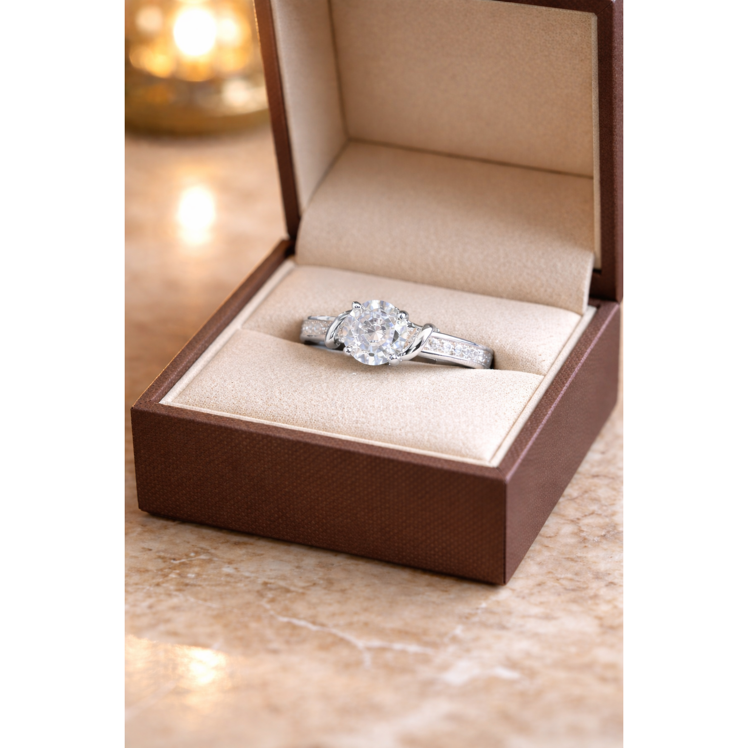 Round cut gemstone twist solitaire ring in silver finish displayed inside beige luxury jewelry box