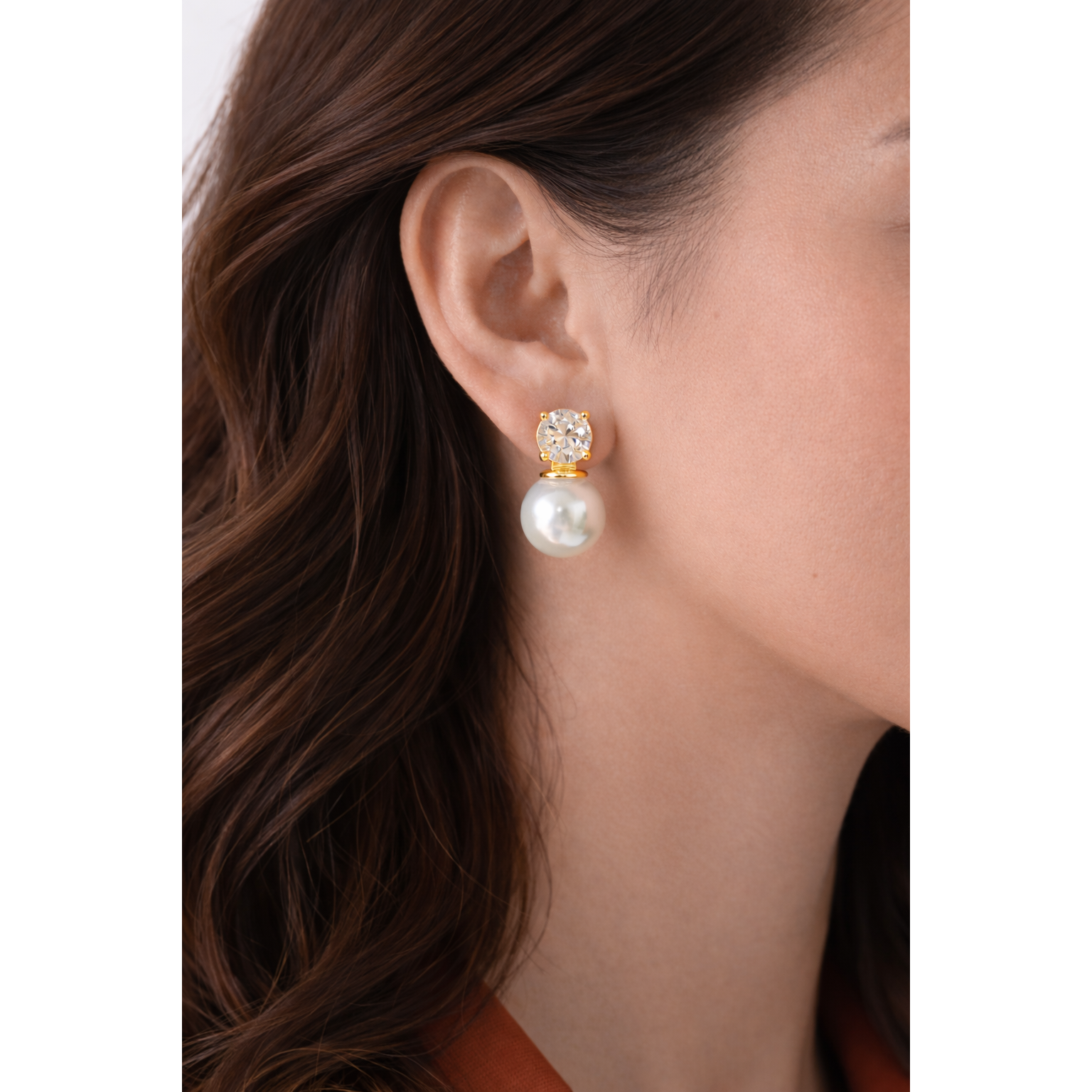 Woman wearing gold pearl and zircon drop earrings close-up showing natural drop length and gold setting”