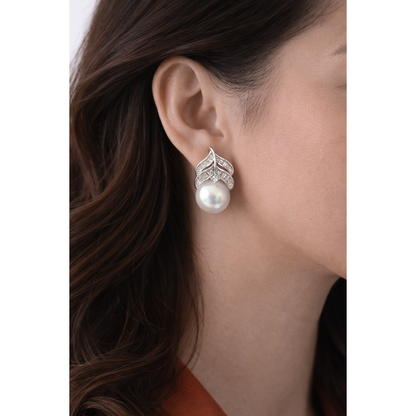Silver leaf-design pearl zircon stud earring worn on model side-profile showing pearl drop and zircon detailing